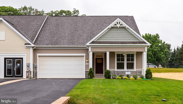 craftsman house featuring a garage, covered porch, and a front lawn