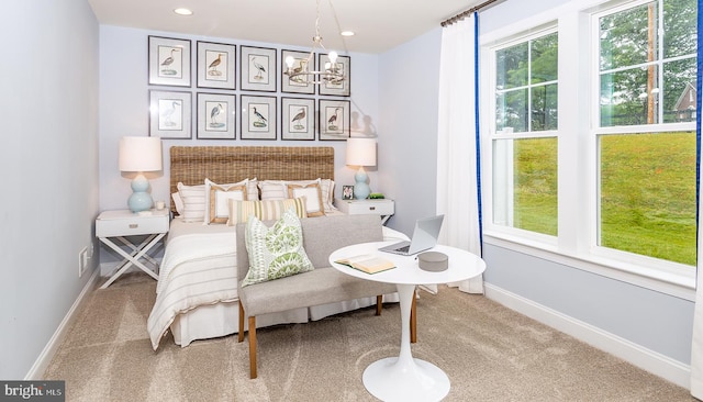 carpeted bedroom with a chandelier