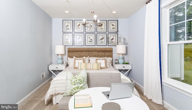 carpeted bedroom featuring a chandelier