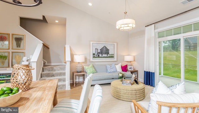 living room with lofted ceiling and light wood-type flooring