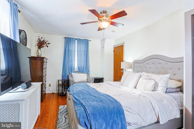 bedroom with hardwood / wood-style floors and ceiling fan