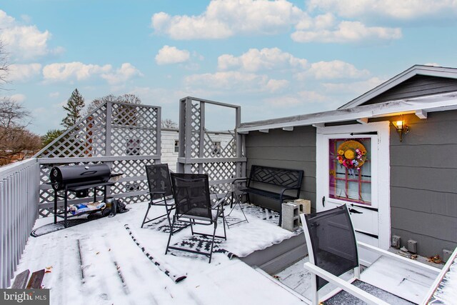 snow covered deck featuring a grill