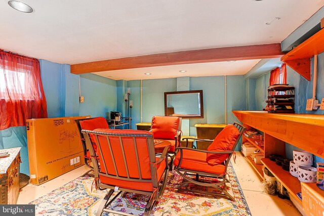 sitting room featuring beam ceiling