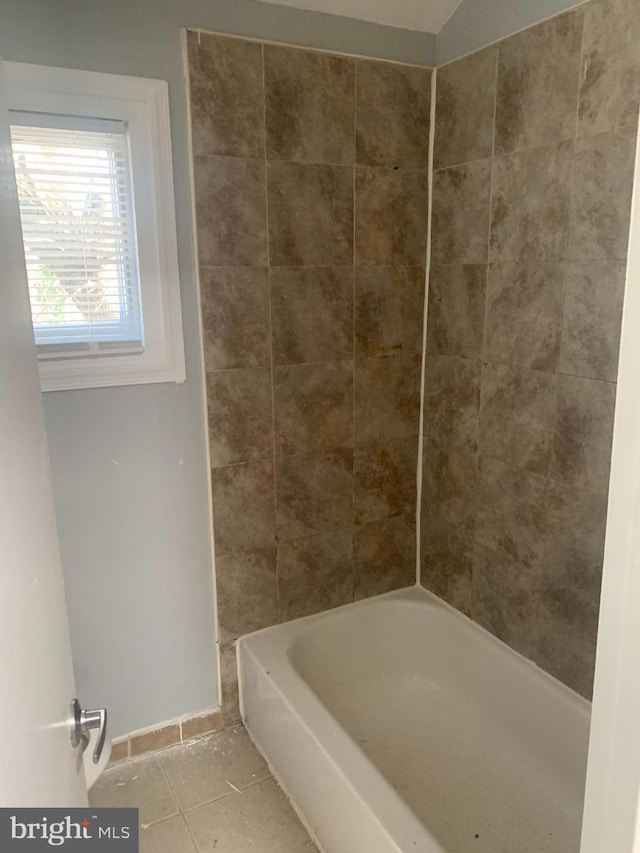 bathroom with tile patterned flooring and tiled shower / bath combo