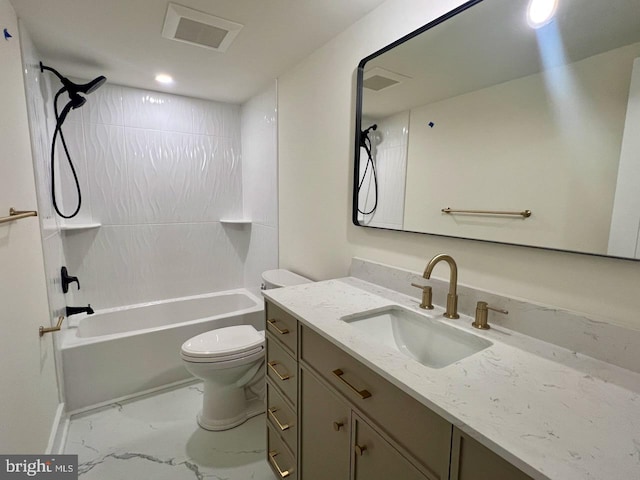 full bathroom featuring vanity, tiled shower / bath combo, and toilet