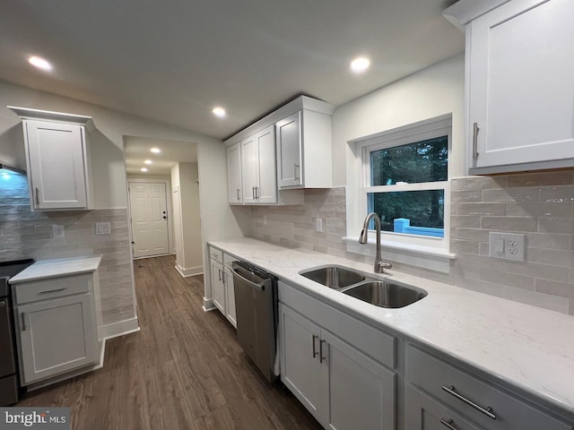 kitchen with dark wood-type flooring, sink, white cabinets, and stainless steel dishwasher