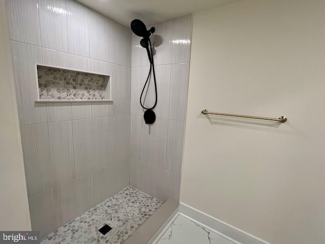 bathroom with a tile shower