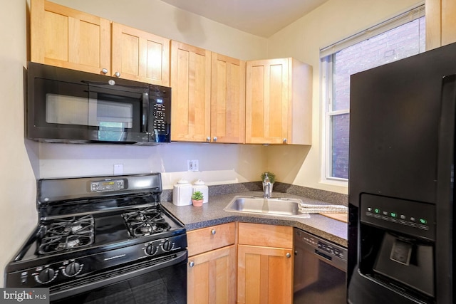 kitchen with light brown cabinetry, sink, and black appliances