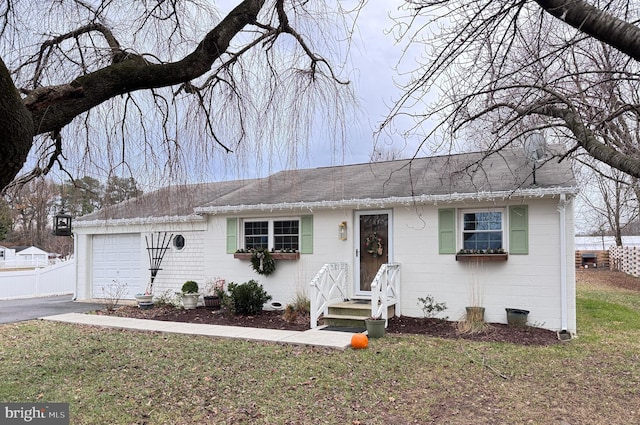 single story home featuring a garage and a front lawn