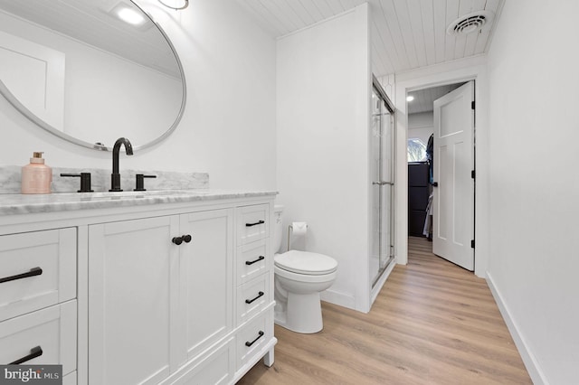 bathroom with hardwood / wood-style flooring, vanity, and toilet