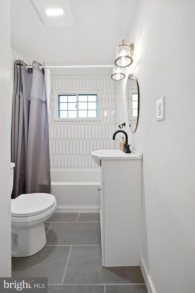 full bathroom featuring tile patterned flooring, vanity, toilet, and shower / tub combo with curtain