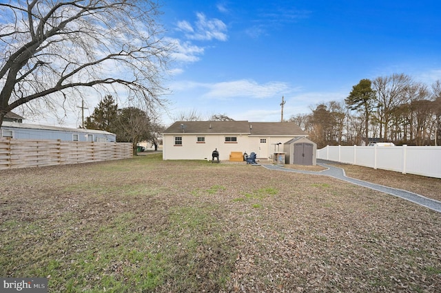 rear view of property featuring a storage shed