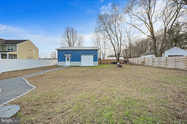 view of yard featuring a garage and an outdoor structure