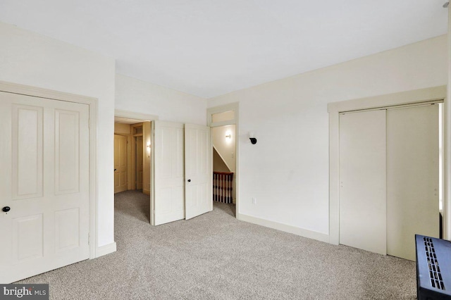 unfurnished bedroom with light colored carpet