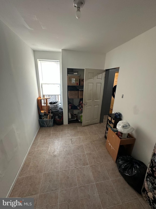 hall with light tile patterned floors