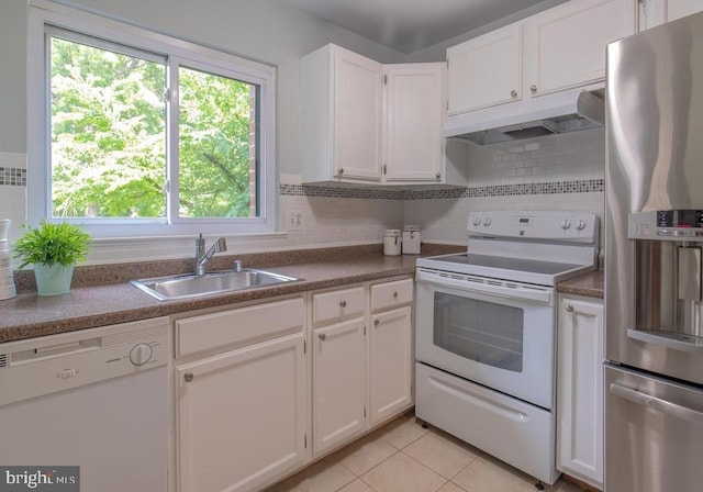 kitchen featuring white cabinets, light tile patterned floors, white appliances, and sink