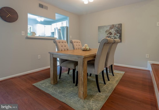 dining area featuring dark wood-type flooring