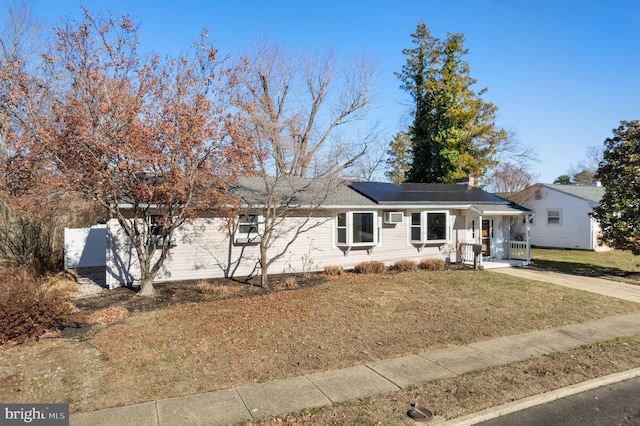 view of front of house featuring a front lawn and covered porch