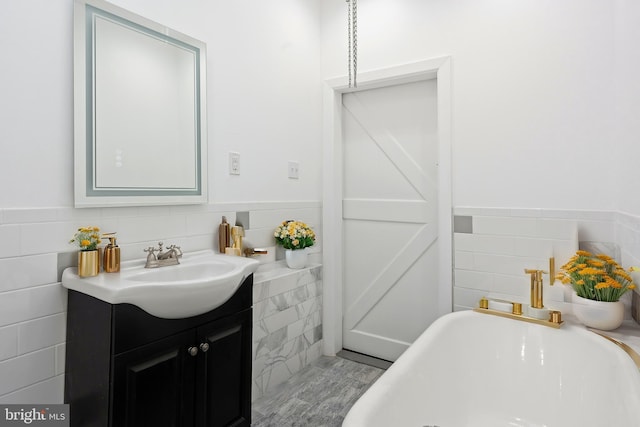 bathroom with vanity and a tub