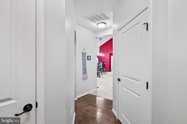 corridor with dark hardwood / wood-style flooring