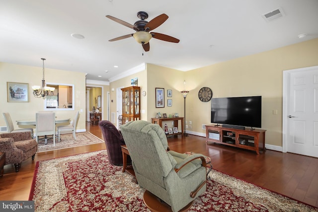 living room featuring ceiling fan with notable chandelier and dark hardwood / wood-style floors