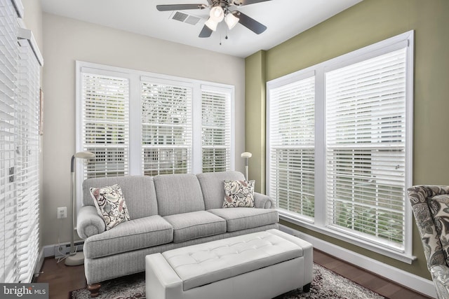 living room featuring ceiling fan, wood-type flooring, and plenty of natural light