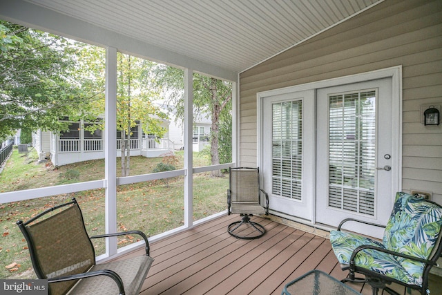 sunroom / solarium featuring lofted ceiling