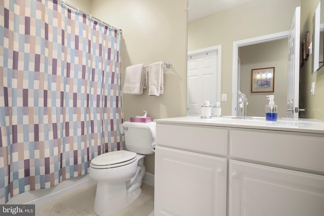 bathroom featuring toilet, vanity, and tile patterned flooring