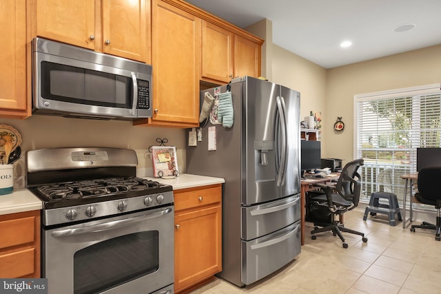 kitchen with appliances with stainless steel finishes and light tile patterned flooring