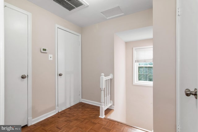 corridor with dark parquet flooring