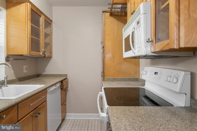 kitchen with sink, light tile patterned flooring, and white appliances