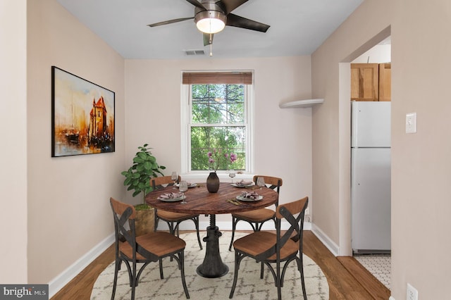 dining area featuring hardwood / wood-style floors and ceiling fan