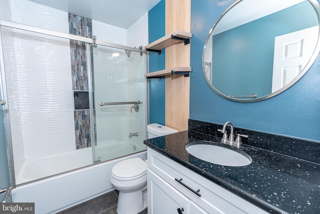 full bathroom with toilet, bath / shower combo with glass door, and vanity