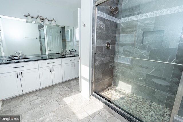 bathroom featuring walk in shower and vanity