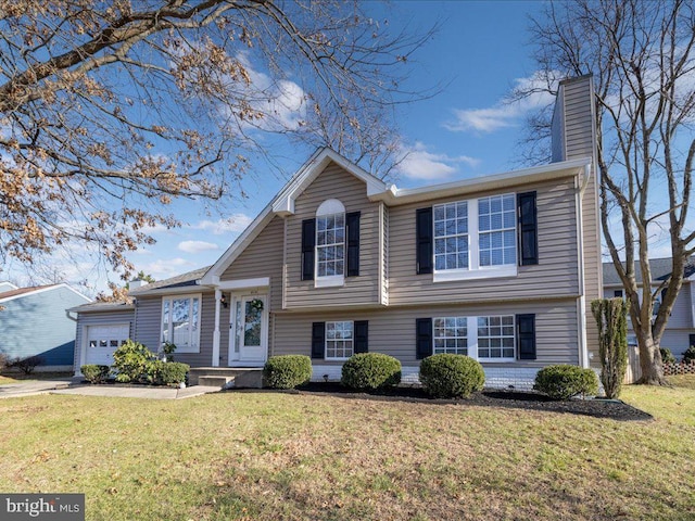 split level home featuring a front yard and a garage