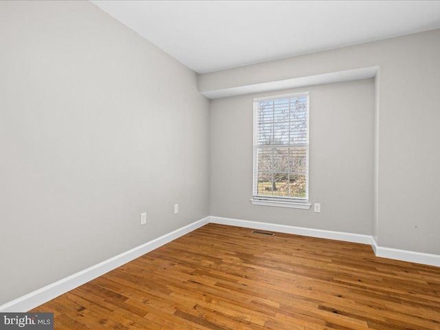 spare room with wood-type flooring