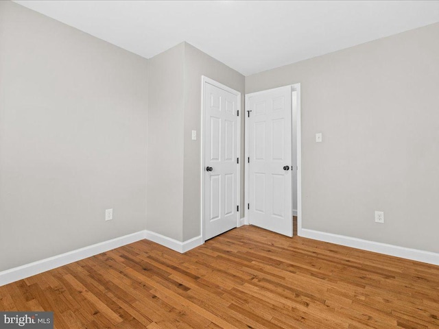 spare room with wood-type flooring