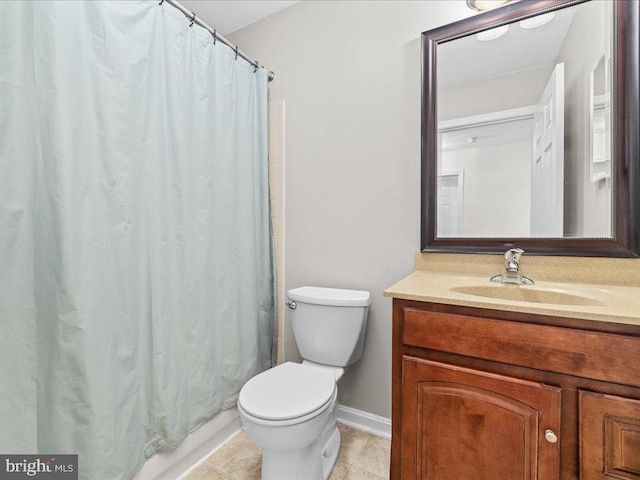 bathroom featuring tile patterned flooring, vanity, and toilet