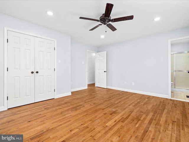 unfurnished bedroom with ceiling fan, a closet, connected bathroom, and light hardwood / wood-style flooring