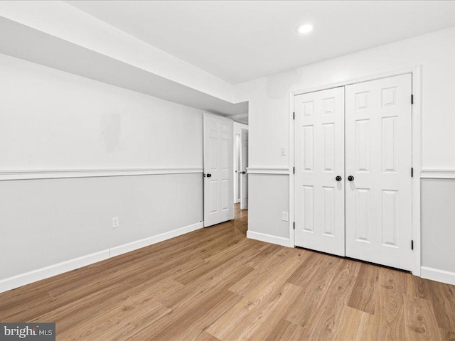 unfurnished bedroom featuring a closet and light hardwood / wood-style floors