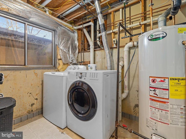 clothes washing area featuring washing machine and dryer and water heater