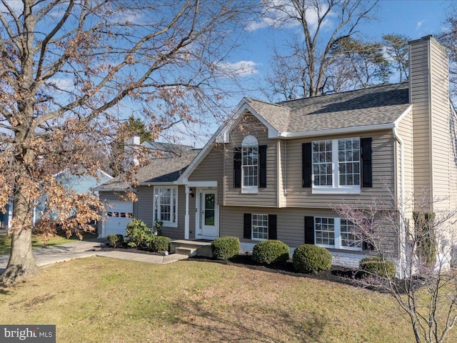 view of front of house with a garage and a front lawn