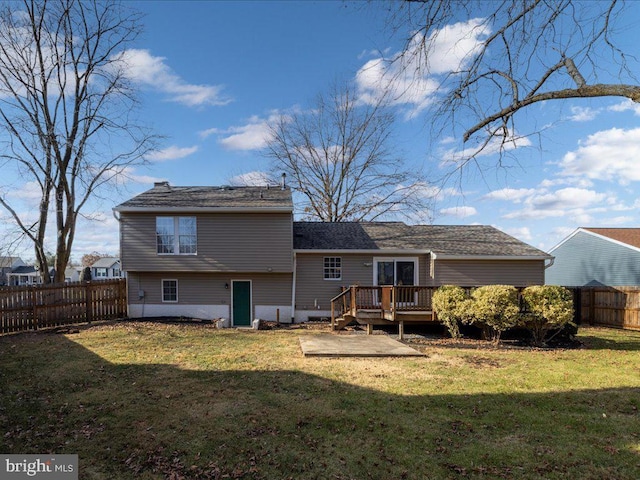 back of property featuring a lawn and a wooden deck