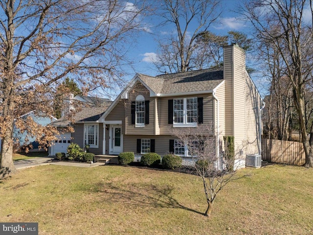 tri-level home with central AC and a front lawn