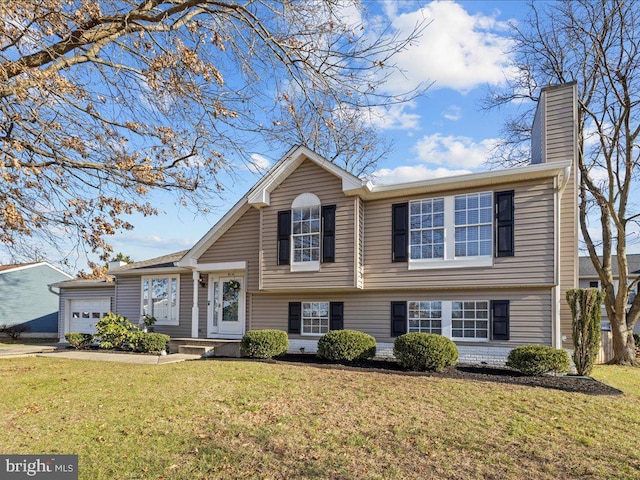 split level home with a front lawn and a garage