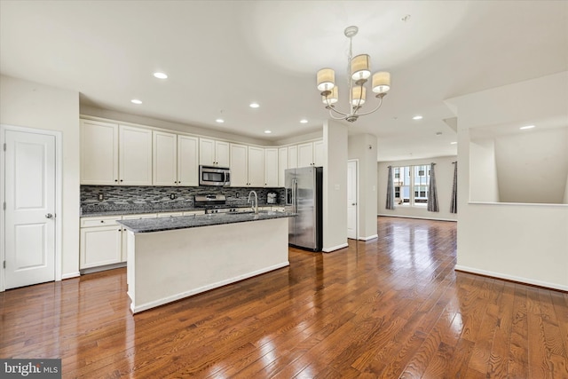 kitchen featuring decorative light fixtures, white cabinets, and appliances with stainless steel finishes