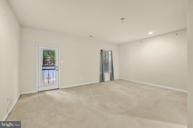 unfurnished room with light carpet