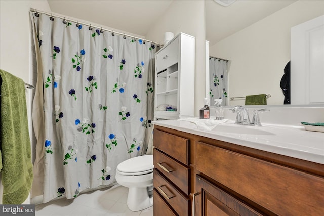 bathroom with toilet, tile patterned flooring, and vanity