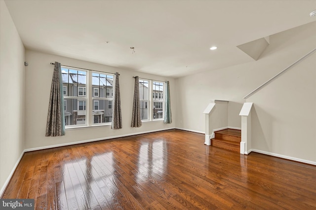 unfurnished living room featuring wood-type flooring