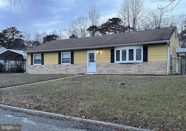 ranch-style home with a front lawn and a carport